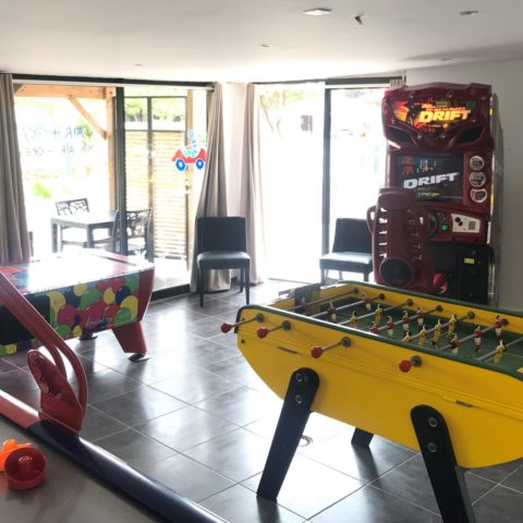 Games room with table soccer and arcade machines.