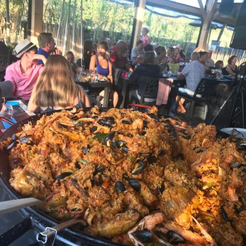 Giant paella served in a lively restaurant.