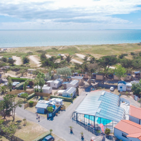 Aerial view of campsite with swimming pool and beach