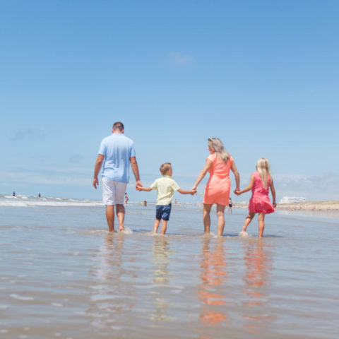 Family walking on a sunny beach