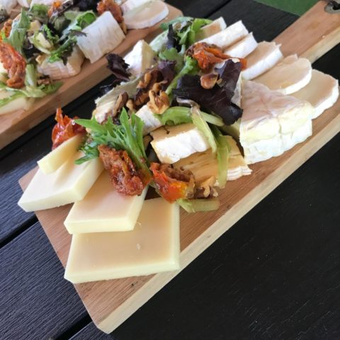 Cheese platter with salad and nuts.